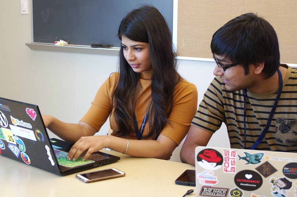 Urvika Gola, former Outreachy intern, hacks on the open source Android application, Lumicall, with former Google Summer of Code intern, Pranav Jain. (Photo CC-BY Sage Sharp.)